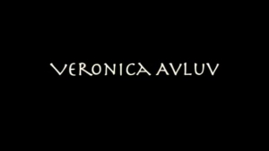 Veronica Avluv is kneeling in a hotel room and sucking her new boyfriend's big cock.