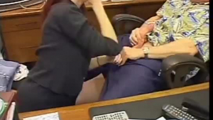 Mature secretary with glasses is giving a gentle titjob to her colleague from work
